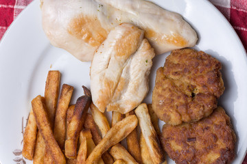 Chicken meat meatballs and french fries on the plate