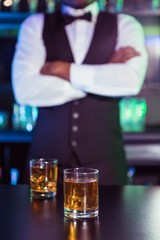 Two glasses of whiskey on bar counter