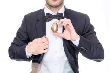 Easter man holding a golden egg 