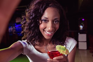 Portrait of young woman having a cocktail