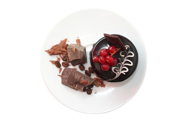 Cake with pieces of dark chocolate on white plate