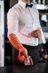 Fototapeta premium Bartender accepting a credit card at bar counter