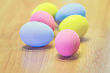 Easter eggs on wooden table, vintage style