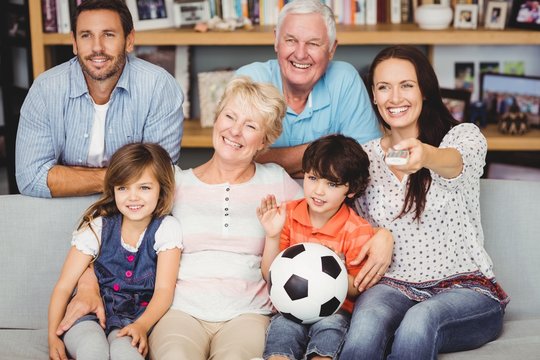 Smiling Family Watching Football Match