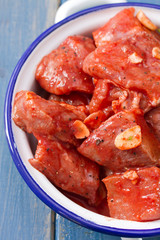 pork in marinate with garlic and bay leaf on dish