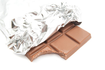 milk chocolate in a foil on white
