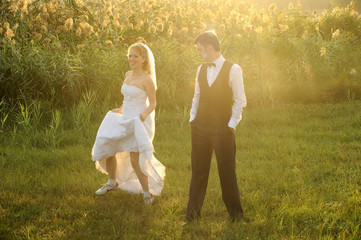 Bride and Groom Having Fun in the Meadow
