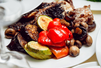 Fried meat with salad on a white plate.