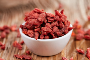 Goji berries in a white china bowl on a table
