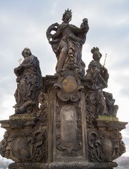 Fototapeta na wymiar Statues St. Barbara, St. Margaret and St. Elizabeth on the Charles Bridge in Prague, Czech Republic