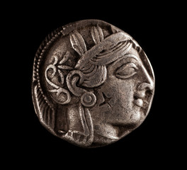 Ancient Greek silver coin on a black background