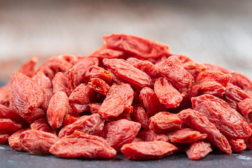 Pile of goji berries on a black stone plate