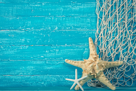 Starfish and fishing net on blue