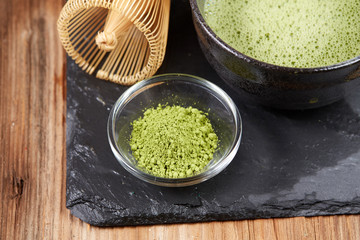 Green matcha tea on a wooden table