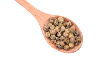 Dry Green pepper on a wooden spoon corn isolated