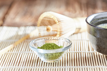 Green matcha tea preparation set on a bamboo table mat