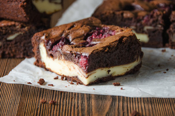 Raspberry brownie on wooden background