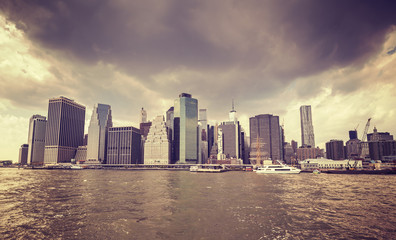 Purple old film stylized rainy clouds over Manhattan waterfront, NYC.