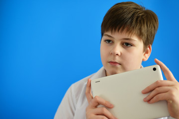 Portrait of teenage boy with tablet PC in hands