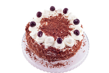 Black forest cake decorated with whipped cream and cherries. 