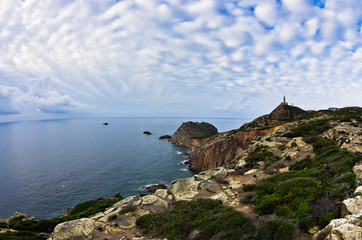 Fototapeta na wymiar Lighthouse at Capo Sandalo on west coast of San Pietro island, Sardinia, Italy