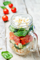 White beans cucumber tomato red pepper feta spinach salad in a j