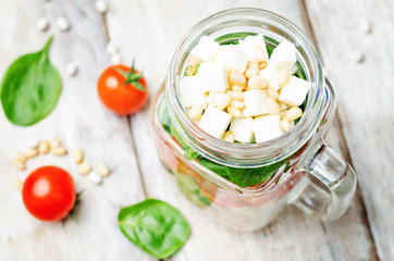 White beans cucumber tomato red pepper feta spinach salad in a j