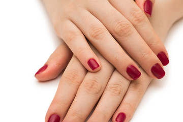 Fototapeta premium Woman hands with red nail isolated on white