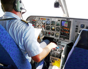 pilot busy with  flyig small plane - obrazy, fototapety, plakaty