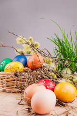 Easter eggs in the basket on a wooden table