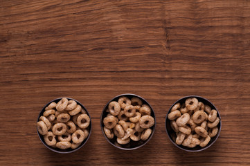 Cereals in metal bowl on brown wooden table