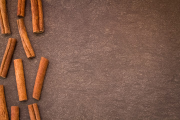 Cinnamon sticks on light brown background