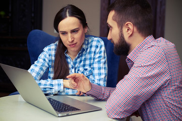 man telling something to smiley woman