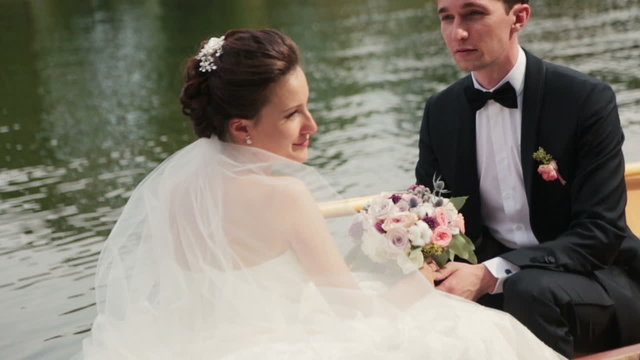 Charming wedding couple hold hands on the canoe. Honeymoon in Paris