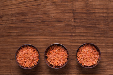 red lentils in metal bowl on brown table