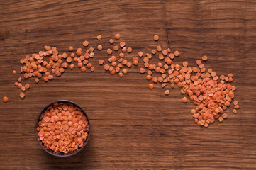 red lentils in metal bowl on brown table