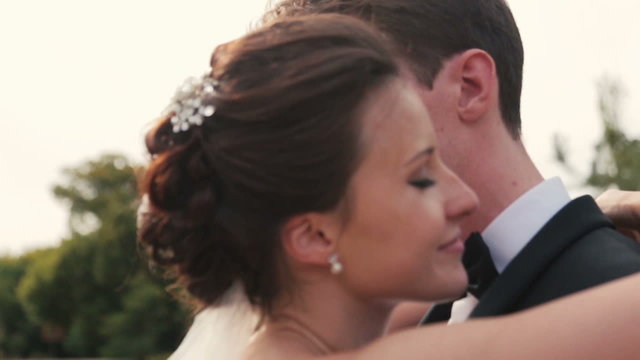 Young wedding couple softly hug close up. Elysian Fields, Paris on background