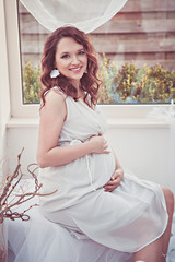 Portrait of romantic smiling pregnant woman
