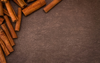Cinnamon sticks on light brown background