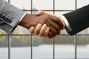 Businessman shake hands at daytime.