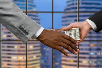 Manager handing money near window.