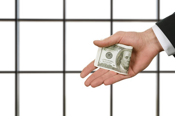 Businessman holding money in office. 