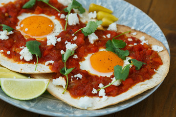 Breakfast with fried egg and sauce on grilled tortilla, Mexicanhuevos rancheros