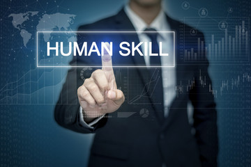 Businessman hand touching HUMAN SKILL   button on virtual screen