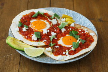 Breakfast with fried egg and sauce on grilled tortilla, Mexicanhuevos rancheros © fazeful