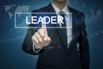 Businessman hand touching LEADER  button on virtual screen