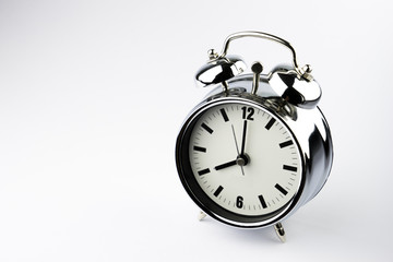 Metal Alarm clock work time on white background 10 am.