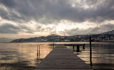 Naklejka premium scenic sunset looking out over a boat jetty in mountains
