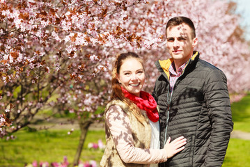 Couple in love walking in park at sunny spring day