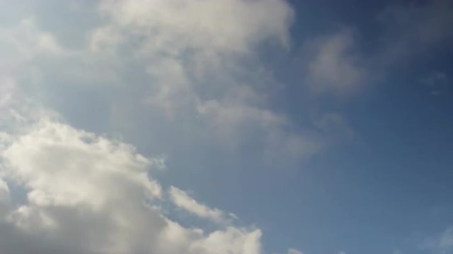 Siblings swinging in time together, slow motion, silhouette in the sky